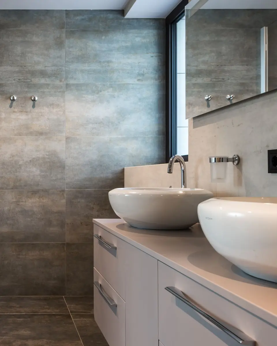 Bathroom with twin vessel basins and a glass shower